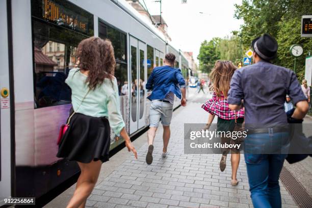 group of young people on a bus/tram stop - moving after stock pictures, royalty-free photos & images