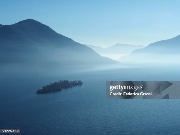 winter fog hovering over the brissago islands and lake maggiore - マジョーレ湖 ストックフォトと画像