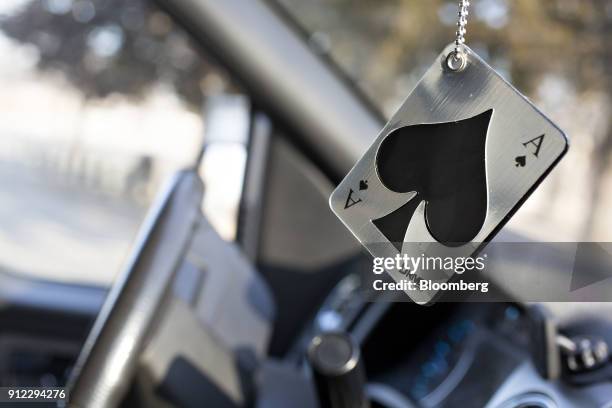 An Energizer Holdings Inc. Driven by Refresh Your Car! brand air freshener hangs from a rearview mirror in Tiskilwa, Illinois, U.S., on Tuesday, Jan....