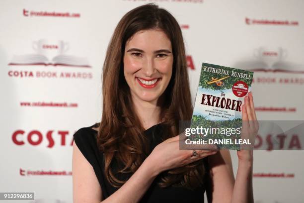 British author Katherine Rundell poses with her 'Children's Book' Award winning book 'The Explorer' as she arrives for the 2017 Costa Book Awards in...