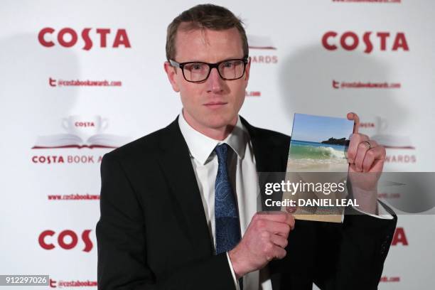 Patrick Charnley, son of the late British poet and author Helen Dunmore poses with Helen's 'Poetry' Award winning book 'Inside the Wave' as he...