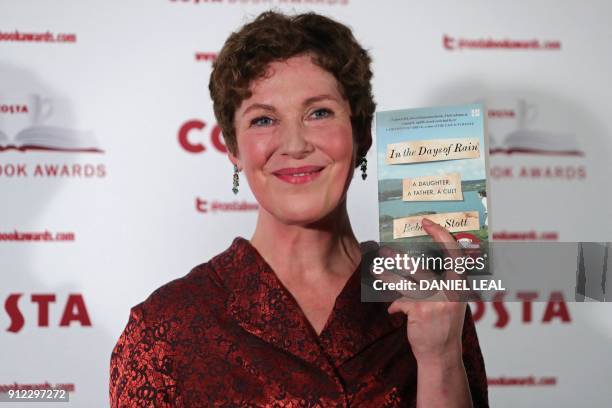 British author Rebecca Stott poses with her 'Biography' Award winning book 'In the Days of Rain' as she arrives for the 2017 Costa Book Awards in...