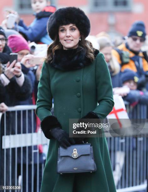 Catherine, Duchess of Cambridge walks through the cobbled streets of Stockholm from the Royal Palace to the Nobel Museum during day one of their...