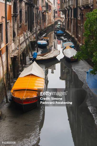Boats are stucked in low tide in a canal on January 30, 2018 in Venice, Italy. An exceptional low tide affected Venice this afternoon creating...
