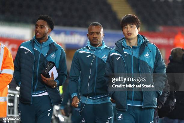 Leroy Fer; Jordan Ayew and Ki Sung-Yueng of Swansea City arrives at the stadium prior to the Premier League match between Swansea City and Arsenal at...