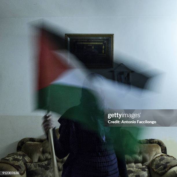 Palestine, Jericho. A woman shows the Palestinan flag. This is the story of Palestinian prisoners"u2019 wives who have turned to sperm smuggling in...