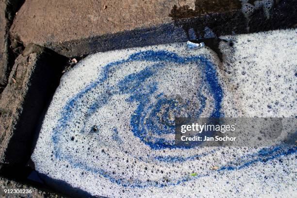 Blue indigo pigment is seen at the top of the water solution siphoned out from a concrete tank at the semi-industrial manufacture near San Miguel, in...