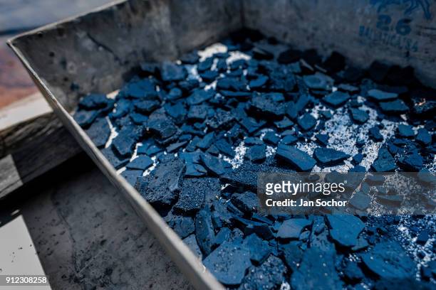 Detail of cracked rocks of indigo paste, dried on the sun, is seen in the metal box at the semi-industrial manufacture near San Miguel, El Salvador...