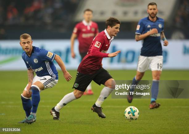 Max Meyer of Schalke and Pirmin Schwegler of Hannover battle for the ball during the Bundesliga match between FC Schalke 04 and Hannover 96 at...