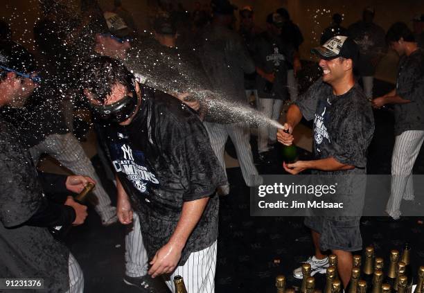 Joba Chamberlain of the New York Yankees is sprayed with champagne as he celebrates in the clubhouse after his team defeated the Boston Red Sox on...