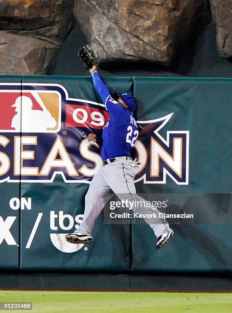 Marlon Byrd of the Texas Rangers crashes against the center field in an attempt to catch the two-run home run Kendry Morales Los Angeles Angels of...