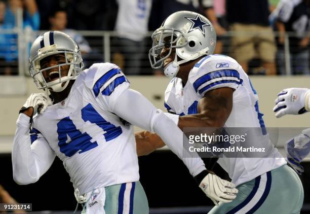 Terence Newman of the Dallas Cowboys celebrates with teammate Ken Hamlin after returning an interception for a touchdown in the fourth quater against...