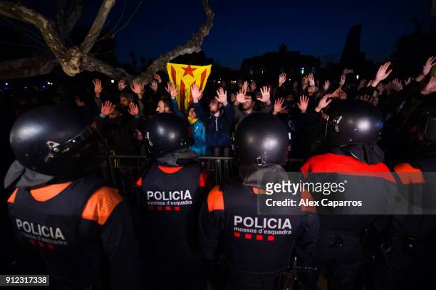 Demonstrators take part in a protest to support former Catalan President, Carles Puigdemont in front of the Parliament of Catalonia on January 30,...