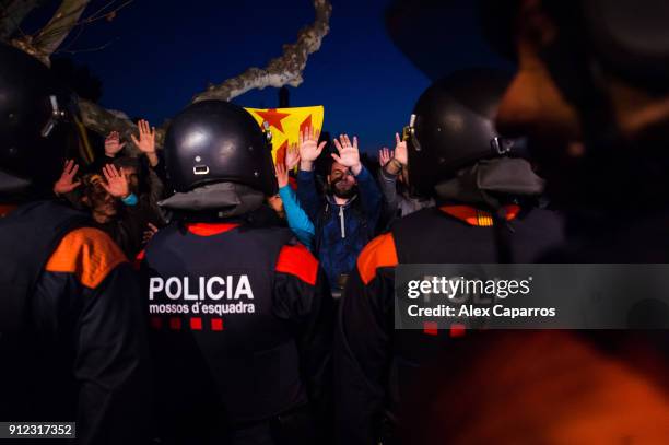 Demonstrators take part in a protest to support former Catalan President, Carles Puigdemont in front of the Parliament of Catalonia on January 30,...