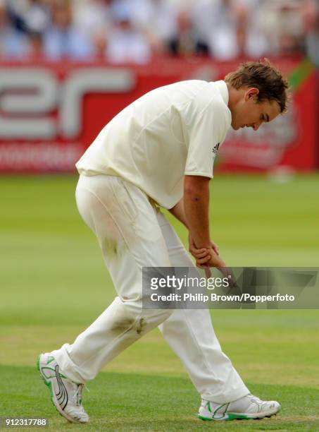 Australia's Nathan Hauritz reacts after dislocating his middle finger while attempting to catch a chance from England's Andrew Strauss during the 2nd...