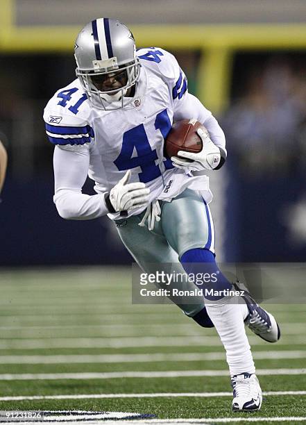 Terence Newman of the Dallas Cowboys returns an interception for a touchdown in the fourth quater against the Carolina Panthers at Cowboys Stadium on...