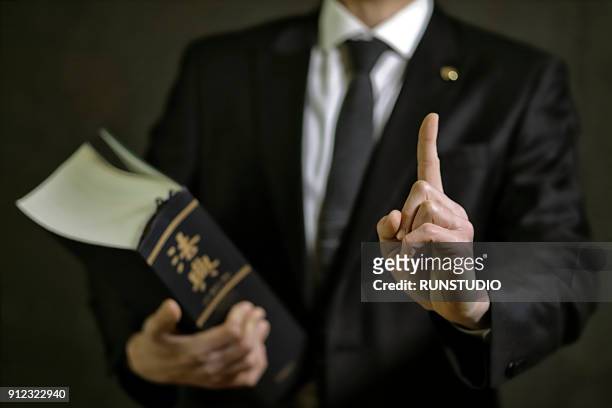 lawyer pointing finger with law book - difensore foto e immagini stock