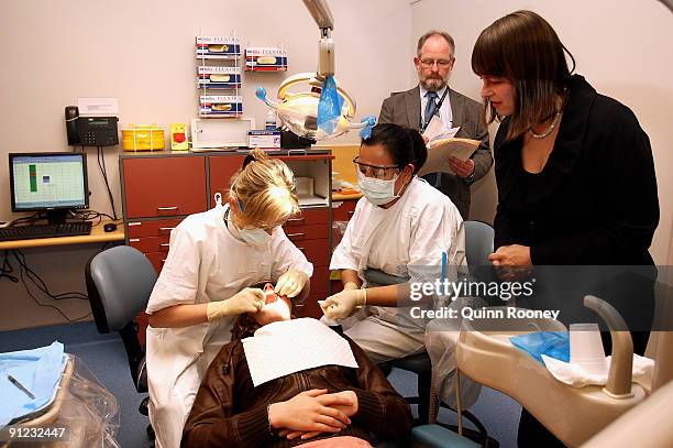 The Minister for Health and Ageing, Nicola Roxon watches on as Jaime Sturre is operated on. The minster is visiting The Royal Dental Hospital...
