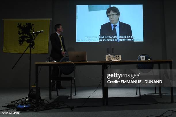 Picture shows a screen displaying a live broadcast of a speech by ousted Catalan separatist leader Carles Puigdemont at the New Year reception of the...