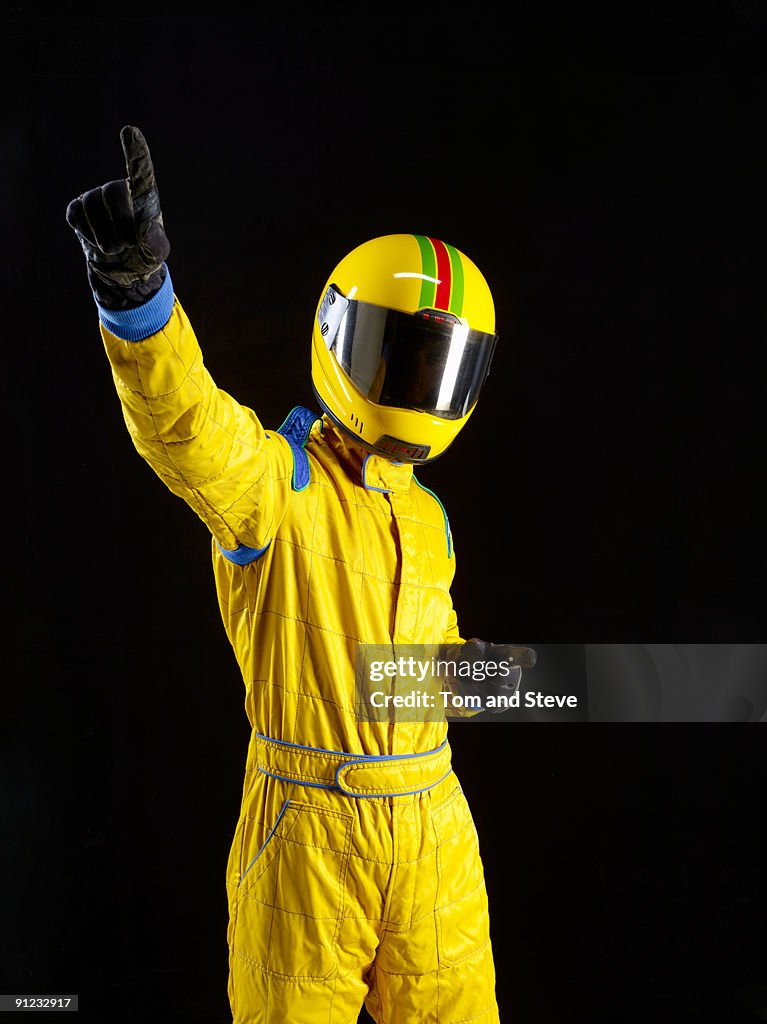 Successful racing driver celebrating on black