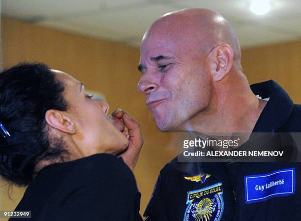 Canadian space tourist and founder of Cirque du Soleil Guy Laliberte jokes with his wife Claudia Barilla during a press conference at Kazakhstan's...