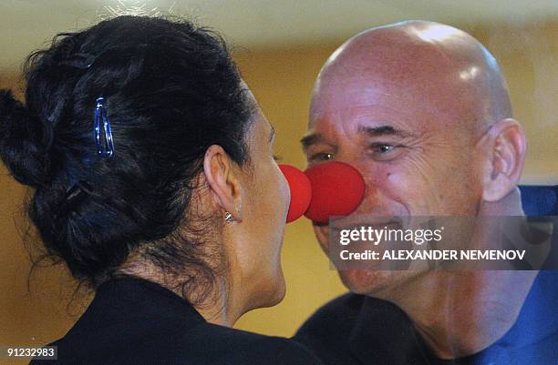 Canadian space tourist and founder of Cirque du Soleil Guy Laliberte jokes with his wife Claudia Barilla during a press conference at Kazakhstan's...