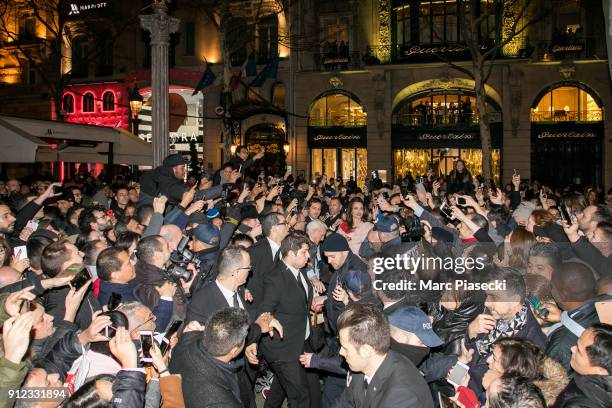 Actress Angelina Jolie is surrounded by the crowd as she leaves the 'Guerlain' store on the Champs-Elysees avenue on January 30, 2018 in Paris,...