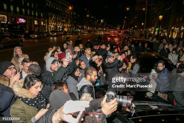 The crowd gather to see actress Angelina Jolie in front of the 'Guerlain' store on the Champs-Elysees avenue on January 30, 2018 in Paris, France.