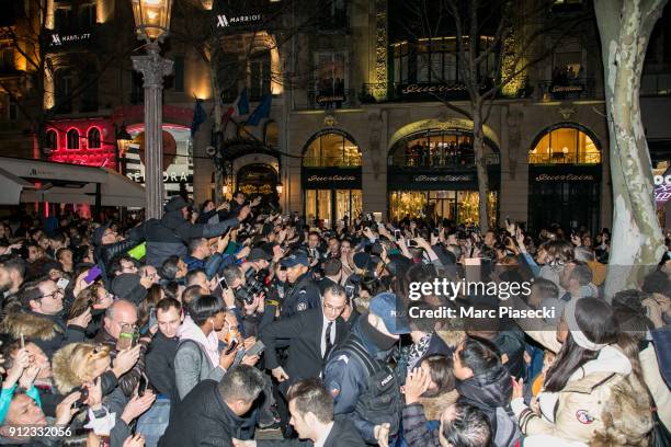The crowd gather to see actress Angelina Jolie in front of the 'Guerlain' store on the Champs-Elysees avenue on January 30, 2018 in Paris, France.