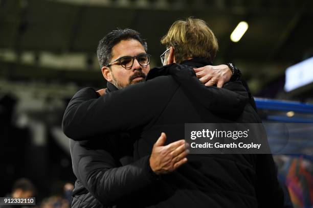 David Wagner, Manager of Huddersfield Town and Jurgen Klopp, Manager of Liverpool enbrace prior to the Premier League match between Huddersfield Town...