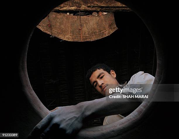 An Afghan man makes 'tandur' ovens at his shop in Kabul on September 29, 2009.Despite a flood of billions of dollars in aid provided by the...