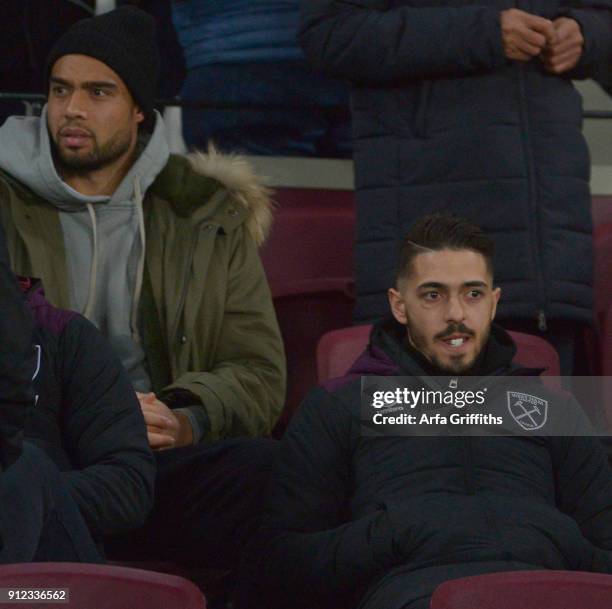 Injured players Winston Reid and Manuel Lanzini of West Ham United watch from the stands prior to the Premier League match between West Ham United...