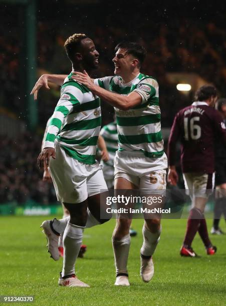 Moussa Dembele of Celtic celebrates with teammate Kieran Tierney after he scores his team's third goal during the Scottish Premier League match...