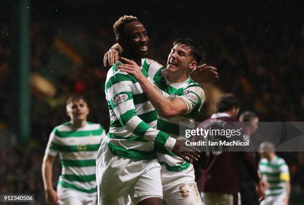 Moussa Dembele of Celtic celebrates with teammate Kieran Tierney after he scores his team's third goal during the Scottish Premier League match...