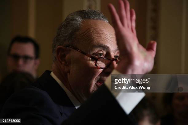 Senate Minority Leader Sen. Chuck Schumer waves as he speaks to members of the media during a news briefing after the weekly Senate Democratic Policy...