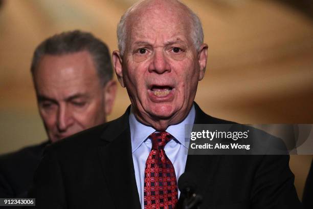 Sen. Ben Cardin speaks to members of the media as Senate Minority Leader Sen. Chuck Schumer listens during a news briefing after the weekly Senate...