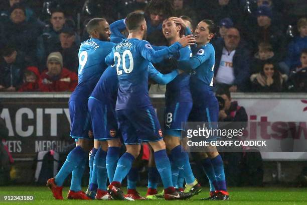 Arsenal's Spanish defender Nacho Monreal celebrates with teammates after scoring the opening goal of the English Premier League football match...