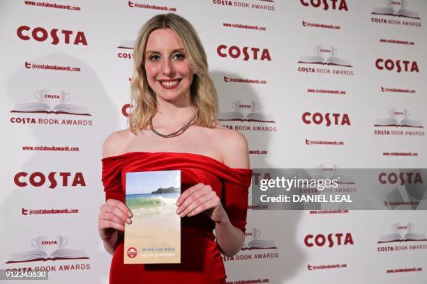 Tess Charnley, daughter of the late British poet and author Helen Dunmore poses with Helen's 'Poetry' Award winning book 'Inside the Wave' after...