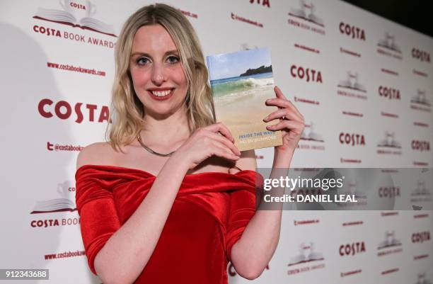 Tess Charnley, daughter of the late British poet and author Helen Dunmore poses with Helen's 'Poetry' Award winning book 'Inside the Wave' after...