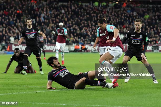 James Tomkins of Crystal Palace fouls Javier Hernandez of West Ham resulting in a penalty during the Premier League match between West Ham United and...