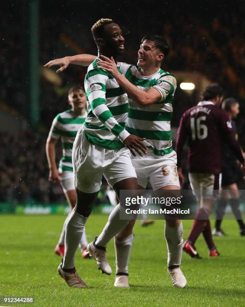 Moussa Dembele of Celtic celebrates with teammate Kieran Tierney after he scores his team's third goal during the Scottish Premier League match...