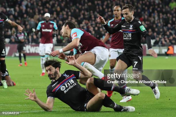 James Tomkins of Crystal Palace fouls Javier Hernandez of West Ham resulting in a penalty during the Premier League match between West Ham United and...
