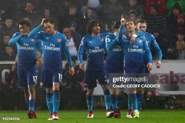 Arsenal's Spanish defender Nacho Monreal celebrates with teammates after scoring the opening goal of the English Premier League football match...