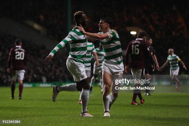 Moussa Dembele of Celtic celebrates with teammate Kieran Tierney after he scores his team's third goal during the Scottish Premier League match...