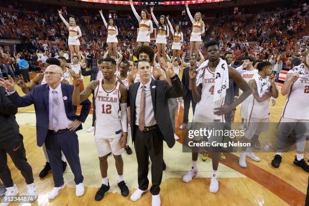 Texas assistant coach Denny Kuiper, Kerwin Roach III , assistant coach Darrin Horn and Mohamed Bamba signaling hook 'em horns with fingers after game...