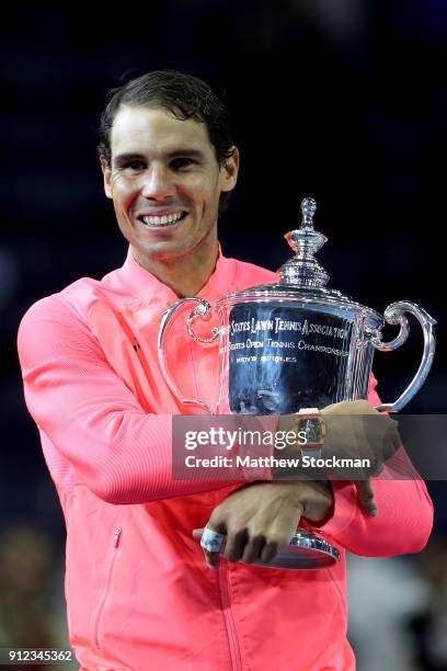 Rafael Nadal of Spain poses with the championship trophy during the trophy ceremony after their Men's Singles Finals match on Day Fourteen of the...