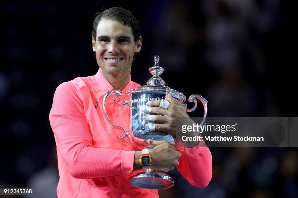 Rafael Nadal of Spain poses with the championship trophy during the trophy ceremony after their Men's Singles Finals match on Day Fourteen of the...
