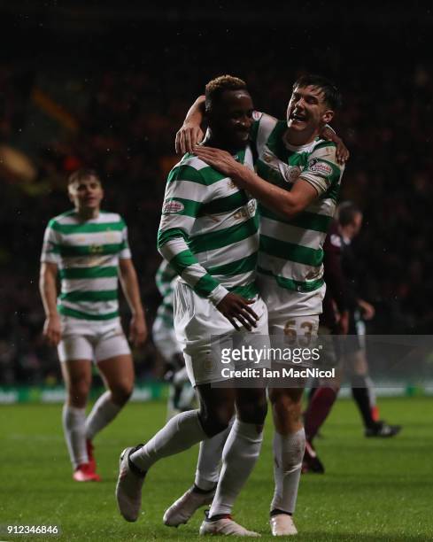Moussa Dembele of Celtic celebrates with teammate Kieran Tierney after he scores his team's third goal during the Scottish Premier League match...