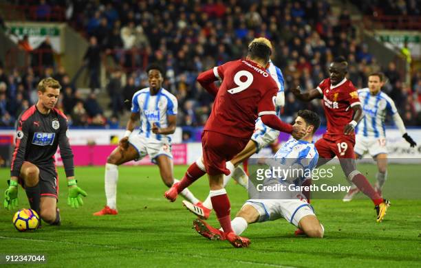Roberto Firmino of Liverpool scores their second goal past goalkeeper Jonas Lossl of Huddersfield Town during the Premier League match between...