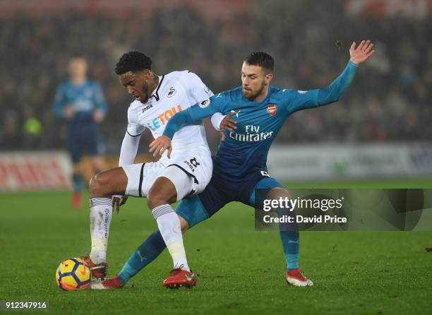 Aaron Ramsey of Arsenal tackles Leroy Fer of Swansea during the Premier League match between Swansea City and Arsenal at Liberty Stadium on January...